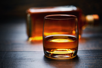 Wooden table with single shots of whiskey