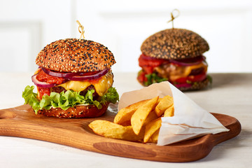 Two burgers with french fries