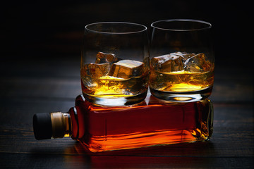 two glasses of whiskey  with ice   . horizontal composition