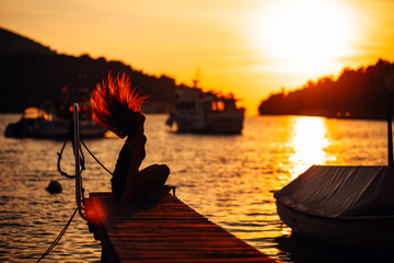 Sensual carefree summer woman enjoying vacation.Seaside stress less lifestyle.Fit traveler enjoying life.Full of energy.Energetic active enthusiastic female.Throwing hair,cheerful sun loving person