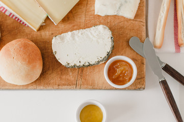 Wooden cheese plate with Italian Gorgonzola cheese, French farmer cheese or formage frais, organic...