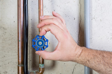 Male hand turning pipe valve