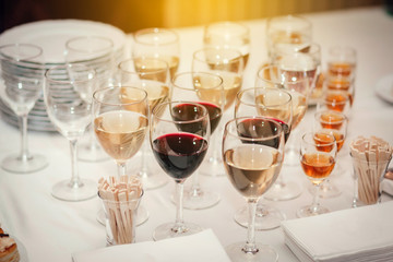 Glass glasses with colored drinks on the table. alcoholic drinks at the buffet