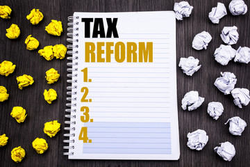 Conceptual hand writing text caption showing Tax Reform. Business concept for Government Change in Taxes Written on notepad note notebook book wooden background with sticky folded yellow and white
