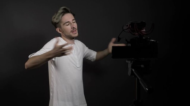 Young man recording in studio a tutorial about how to promote and like videos in social media