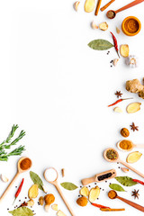 Seasoning background. Dry spices near ginger, garlic, rosemary, laurel leaf on white background top view copy space