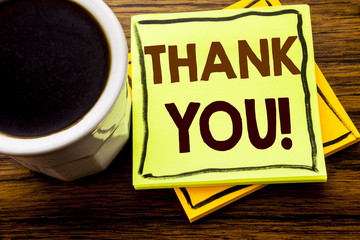 Handwritten text showing Thank You. Business concept for Thanks Message written on sticky note paper on the wooden wood background with coffee cup