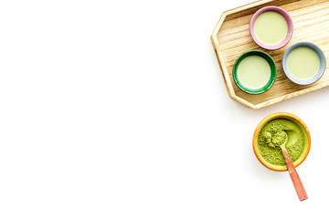 Make matcha tea. Matcha tea in small cups ready to drink on white background top view copy space
