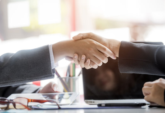 Successful meeting,two confident businessman shake hands with each other at modern office
