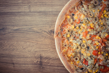 Vintage photo, Vegetarian pizza on rustic board, copy space for text