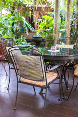 Terrace with chairs, table and plants