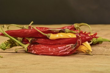 Shrinking and mould chili peppers on wooden background. Rotten chili peppers. Close-up
