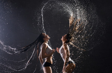 Sexy women in wet underwear having shower together