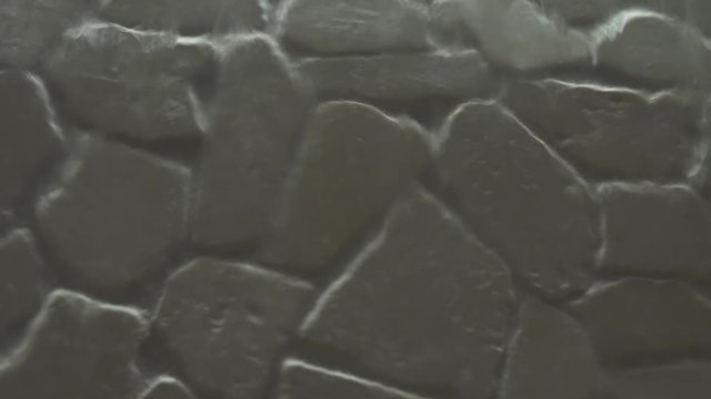 Artificial waterfall on the background of stone wall stock footage video
