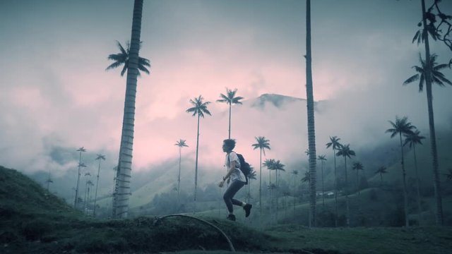 Woman running on the tropical forest of a National park Valle del Cocora, Colombia. Slow motion