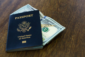 Fototapeta premium One blue American passport with US dollars