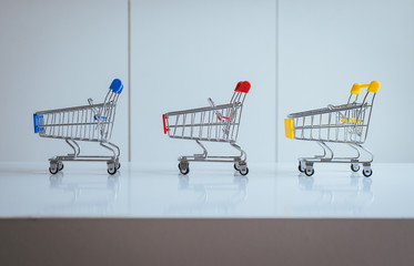 Mini three shopping cart or supermarket trolley empty on table,Finance and money shopping concept