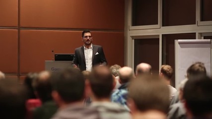 Speaker giving a talk on corporate business event. Audience at the conference hall. Business and Entrepreneurship event.