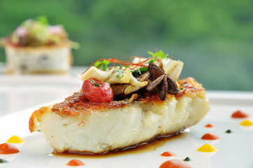 Grilled fish in green background