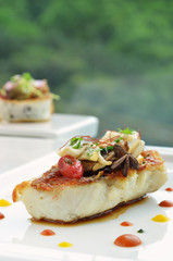 Grilled fish in green background