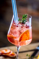 Crédence de cuisine en verre imprimé Cocktail Verre à cocktail sur une vieille planche de bois. Boisson alcoolisée aux fruits tropicaux, poivron rouge, herbe et glace