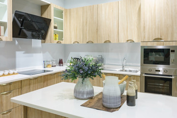 Modern, bright, clean kitchen interior with stainless steel appliances in a luxury apartment.