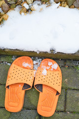 Beach slippers and sunglasses for swimming in the snow
