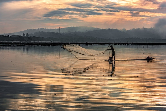 Fisherman in water dam