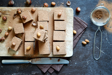 Fototapeta na wymiar Raw vegan brownie with nuts and cocoa 