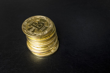 Gold bitcoin coin stacked against a dark background close-up. Bitcoin cryptocurrency
