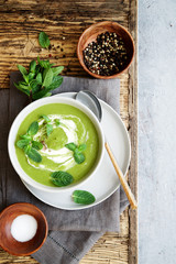 Green peas and broccoli soup . Wooden background, Scandinavian style
