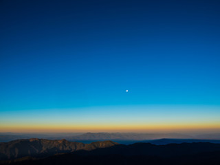 The sun rises on the top of the hill