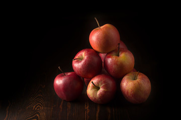 Red apples fruit on a dark background