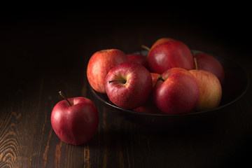 Red apples fruit on a dark background