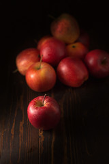 Red apples fruit on a dark background