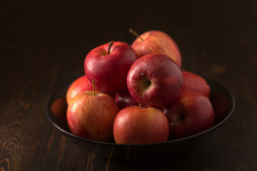 Red apples fruit on a dark background