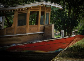 The old wooden boat is an antique not used.