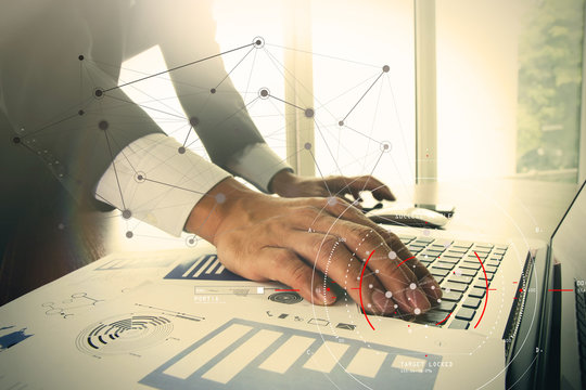Concept of focus on target with digital diagram,graph interfaces,virtual UI screen,connections netwoork.Hipster finance analist working at trendy office