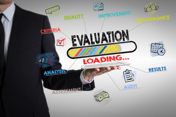 Evaluation concept. Chart with keywords and icons. Man holding a tablet computer