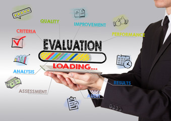 Evaluation concept. Chart with keywords and icons. Man holding a tablet computer.