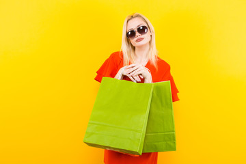 Blonde woman in dress with bags