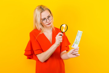 Blonde woman in dress with magnifying glass
