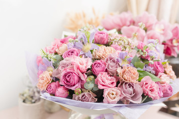 Close-up beautiful luxury bouquet of mixed flowers in glass vases. the work of the florist at a flower shop. Wallpaper