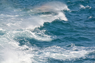 rainbow on splashes of water in the sea.Thailand