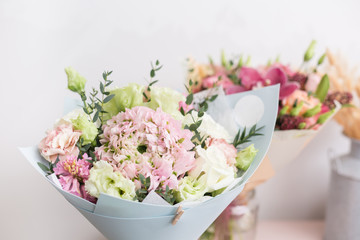 flower shop concept. Close-up beautiful lovely bouquet of mixed flowers on wooden table. Wallpaper