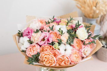 flower shop concept. Close-up beautiful luxury bouquet of mixed flowers on wooden table. Wallpaper