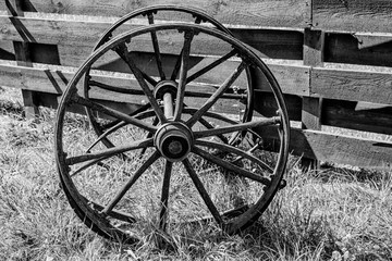 Plakat wooden wheels from an old wagon. black and white photography