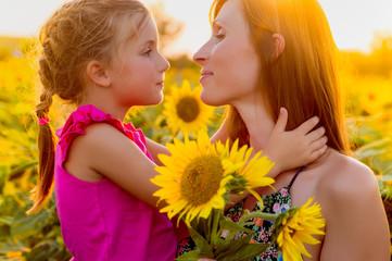Little girl surprising mom with sunflowers at Mother's Day