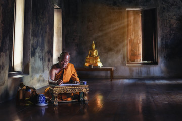 The monk is studying Buddhist activities.