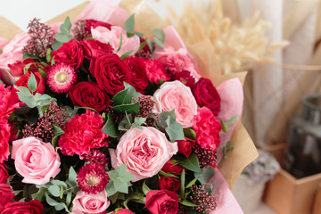 Close-up beautiful luxury bouquet of mixed red and pink flowers in glass vases. the work of the florist at a flower shop. Wallpaper